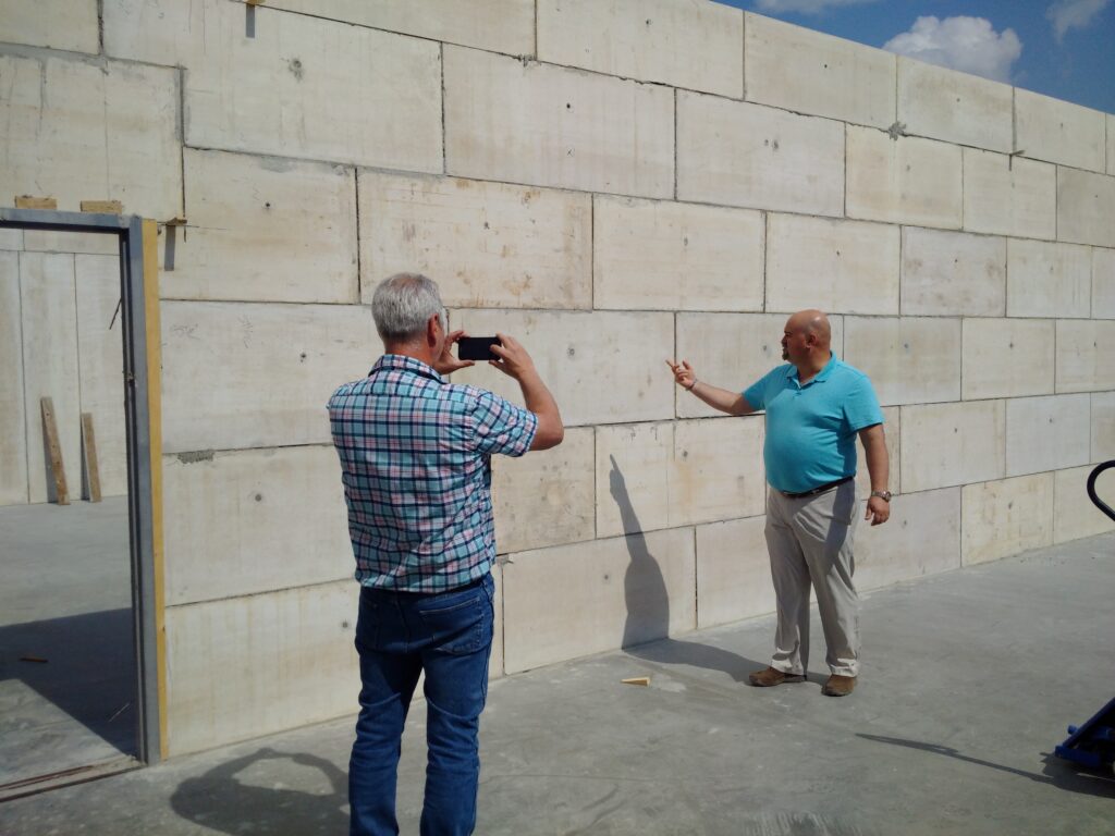 wall with the 2 men taking a picture